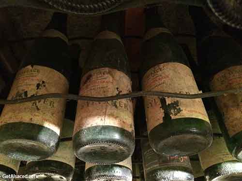 old white wine bottles in the wine cellar in alsace france