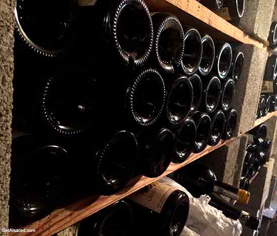 alsace wine bottles in a wine cellar in france