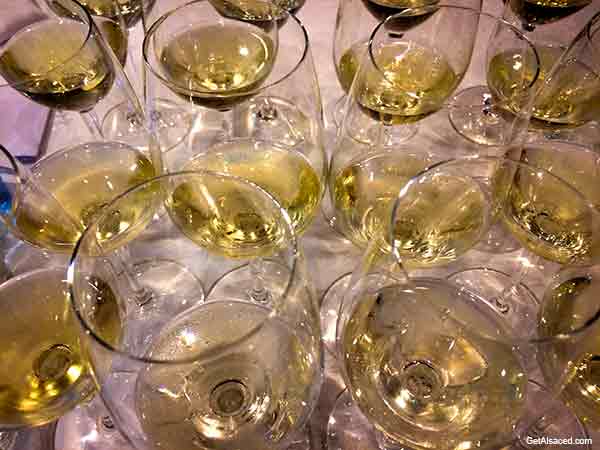 many wine glasses filled with white wine in alsace france